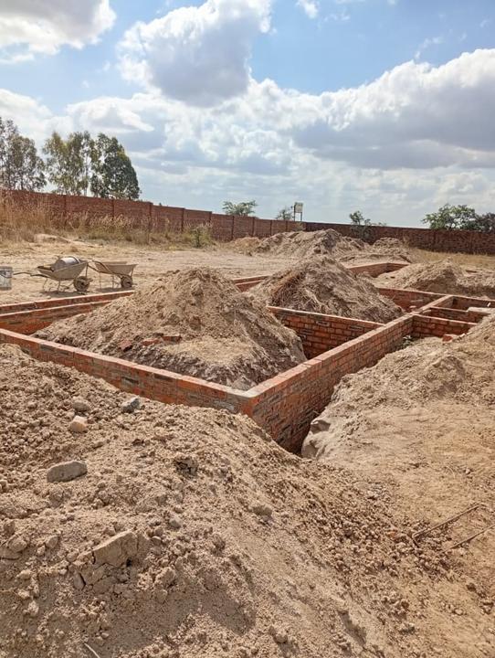 Foundation walls with backfill in progress
