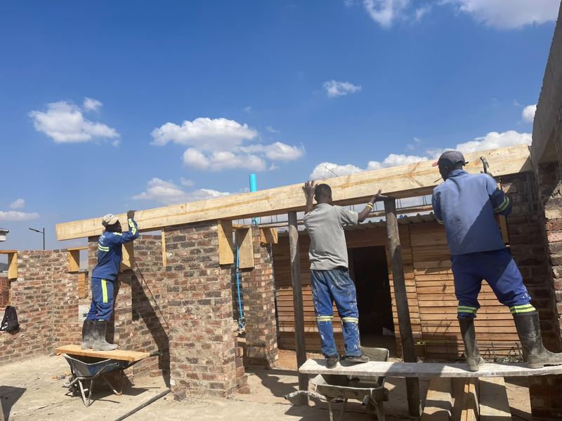 Crew fixing roof timbers