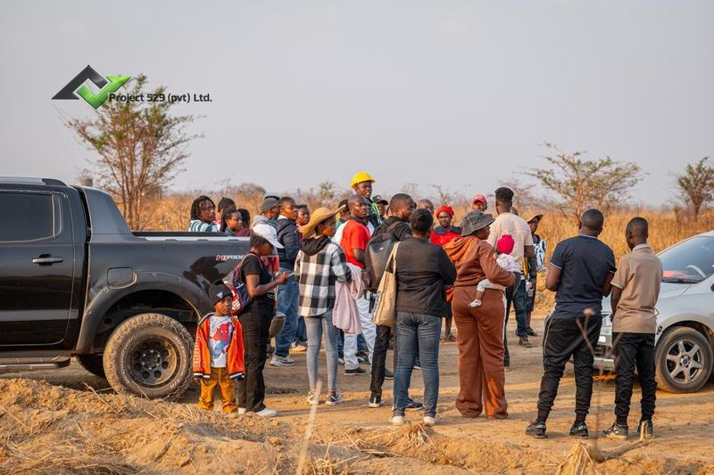 Buyers gathered on site during a tour