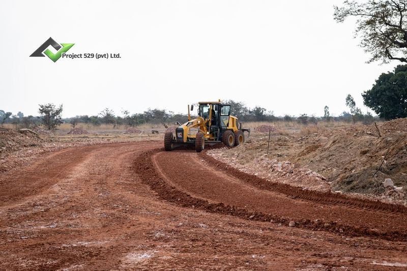 A grader shaping a new road