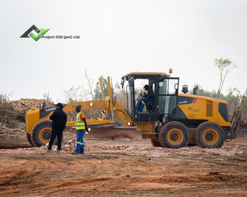 A grader and crew on site