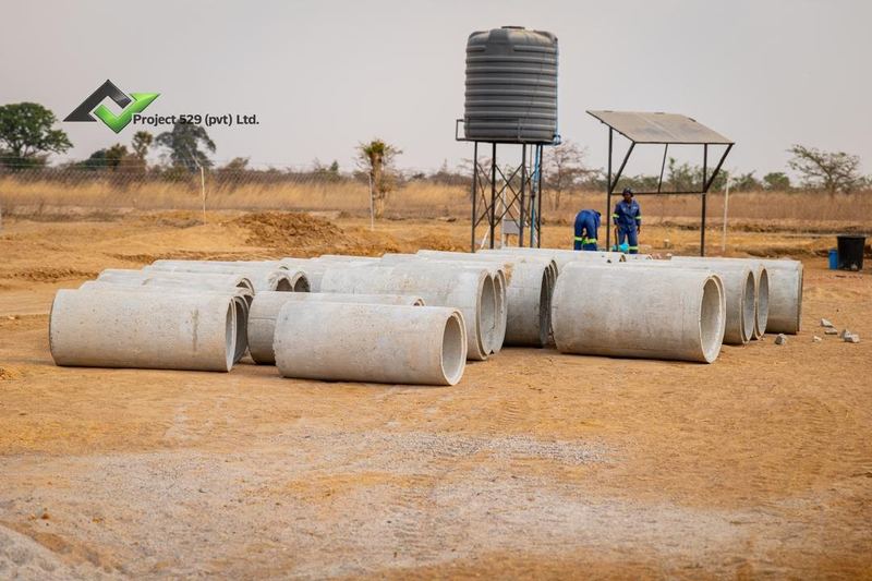 Concrete pipes stacked beside the site water tank