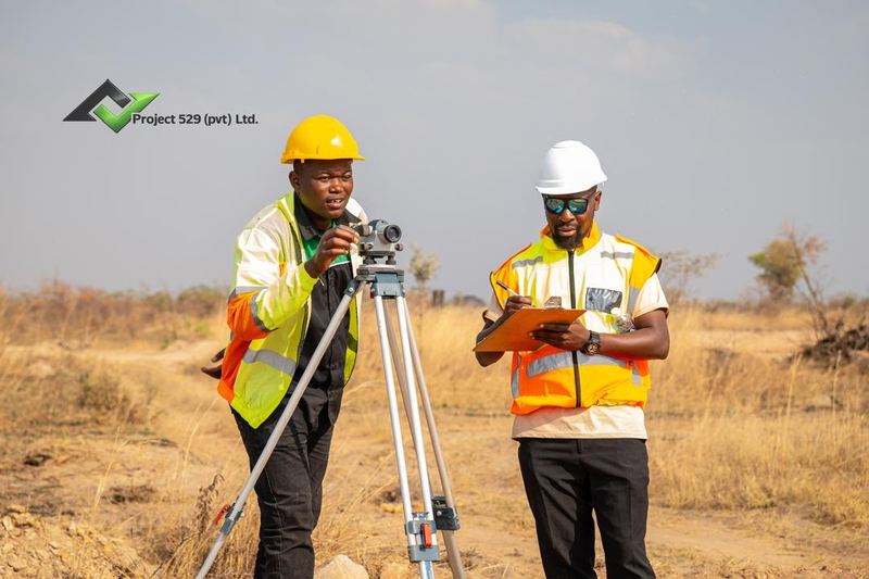 Surveyors taking levels on site